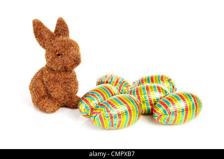 Easter bunny and colorful chocolate easter eggs over white background Stock Photo