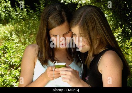 Teenage girls sharing MP3 music on an iPod clone Stock Photo