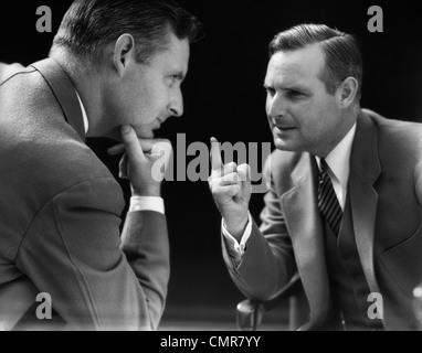 1930s SPECIAL EFFECT OF MAN TALKING AND ARGUING WITH HIMSELF Stock Photo