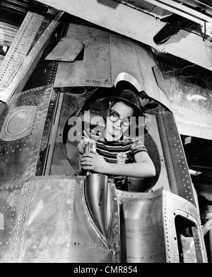 1940s WOMAN RIVETER DRILLING A HOLE IN A B-17 BOMBER ENGINE Stock Photo
