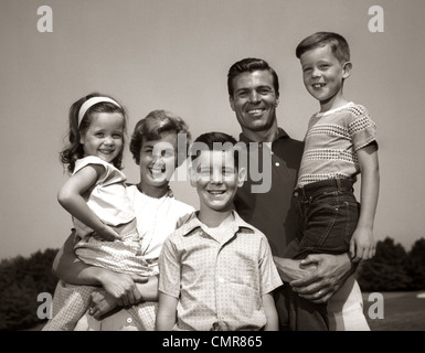 1960s FAMILY PORTRAIT FATHER MOTHER TWO DAUGHTERS SON AND DOG GATHERED ...