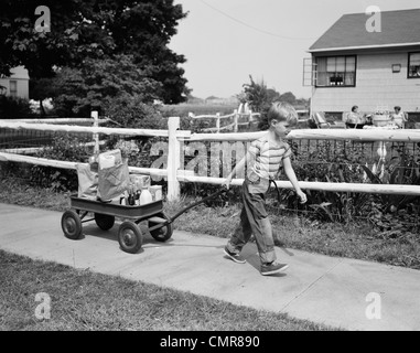 1950s BOY PULLING GROCERIES IN WAGON Stock Photo