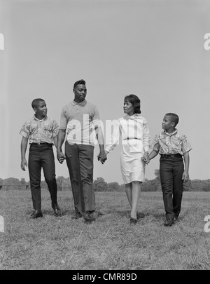1960s AFRICAN AMERICAN FAMILY IN KITCHEN FATHER AND DAUGHTER WATCHING ...
