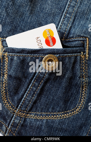 Mastercard logo on credit card poking out of denim pocket - denim material, denim fabric, denim texture macro Stock Photo