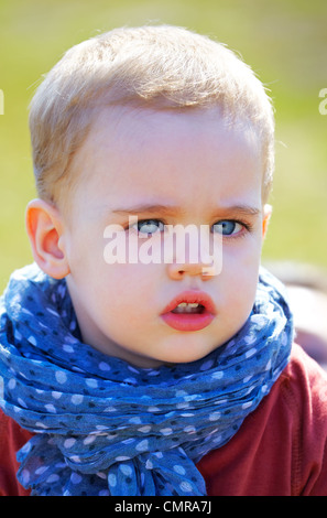 Portrait of a sad little baby boy in springtime. Stock Photo