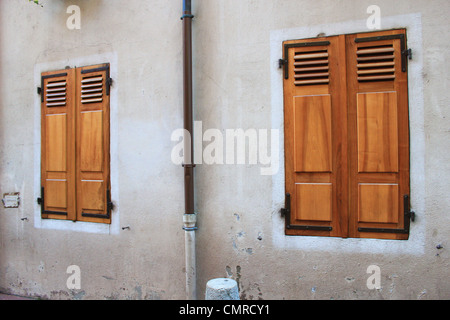 Two wooden shutters closed on a wall at Annecy old city, France Stock Photo