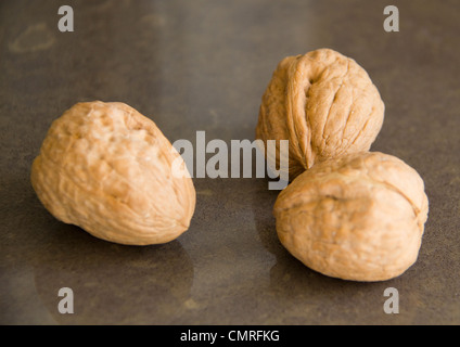 Walnuts on the brown marble background Stock Photo