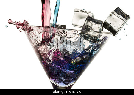 Poured red and blue liqueur in a glass with ice cubes on white background Stock Photo