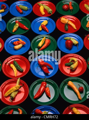 1990s HOT PEPPERS ON COLORFUL PLASTIC PLATES Stock Photo