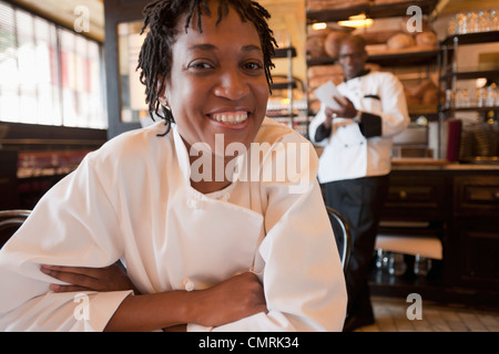 African American chef smiling in restaurant Stock Photo