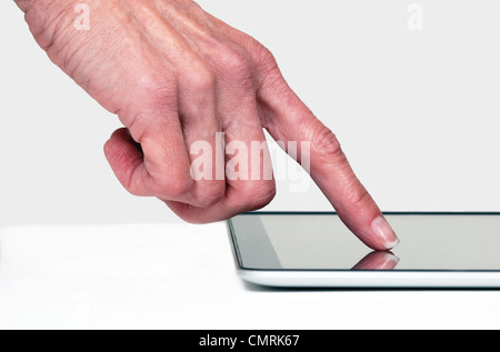 Close up of a finger touching e-tablet Stock Photo