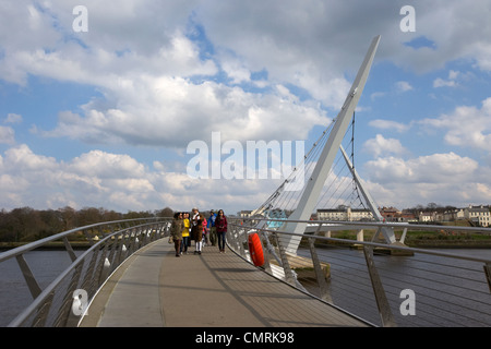 tourists crossing the new peace bridge in Derry city county londonderry northern ireland uk. Stock Photo