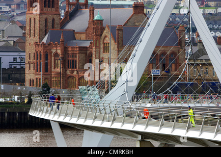 people crossing the new peace bridge in Derry city county londonderry northern ireland uk. Stock Photo