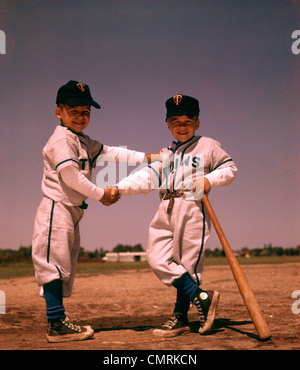1960s LITTLE LEAGUE BASEBALL BOYS IN CAPS AND UNIFORMS EATING HOT DOGS  Stock Photo - Alamy
