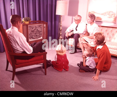 1960s 1970s FAMILY FATHER MAN MOTHER WOMAN SON BOY DAUGHTER GIRL GRANDFATHER GRANDMOTHER WATCHING TELEVISION RETRO Stock Photo