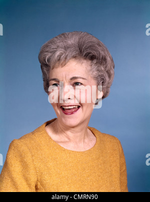 1960s PORTRAIT SMILING ELDERLY WOMAN WEARING ORANGE TOP Stock Photo
