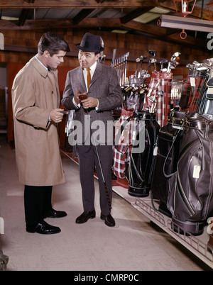 TWO MEN IN GOLF EQUIPMENT SHOP TALKING AND DISCUSSING PURCHASE OF A DRIVER GOLF CLUB Stock Photo