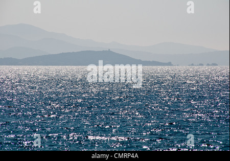 A view of a distant Genoan fort on the Corsican coast and the sparkling blue waters of the Gulf of Ajaccio, Corsica, France. Stock Photo
