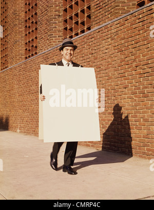 MAN WALKING SANDWICH BOARD HAT RETRO 1950 1950s Stock Photo