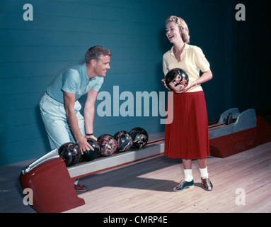 SMILING COUPLE HUSBAND WIFE BOWLING INDOOR 1950s Stock Photo