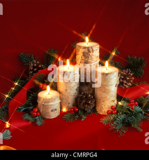 CHRISTMAS STILL LIFE WITH BARK COVERED CANDLES GREENS AND PINE CONES Stock Photo