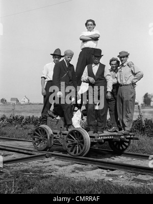 1890s 1900s PORTRAIT GROUP OF MEN RAILROAD WORKERS STANDING ON HANDCAR OUTDOOR Stock Photo
