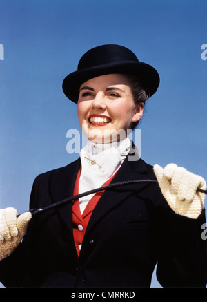 1940s 1950s PORTRAIT SMILING WOMAN WEARING EQUESTRIAN RIDING OUTFIT Stock Photo