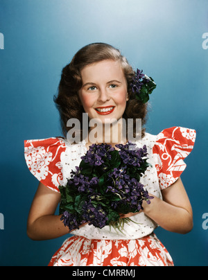 https://l450v.alamy.com/450v/cmrrmj/1940s-1950s-smiling-young-woman-wearing-red-and-white-dress-holding-cmrrmj.jpg