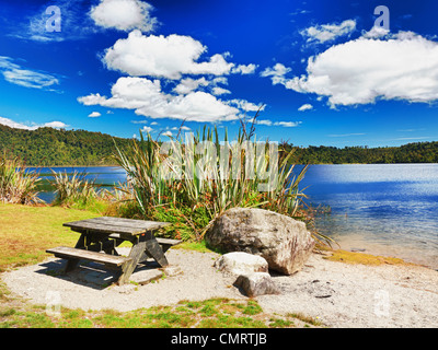 Table for picnic on lakeside in New Zealand. Stock Photo