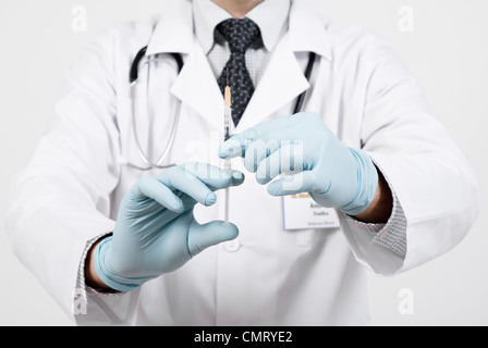 Doctor preparing for making injection with disposable syringe Stock Photo