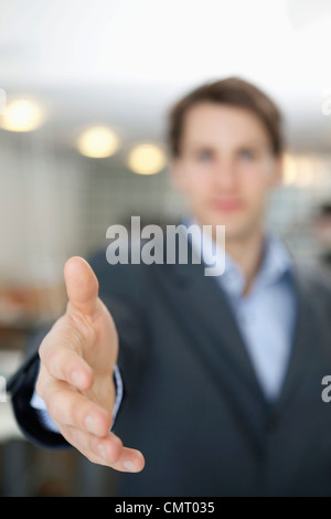 businessman with his hand outstretched in greeting Stock Photo