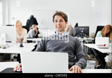 Man sitting and looking away at the office Stock Photo