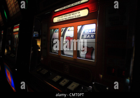 Picture of the display on a brightly lit slot machine in a row of machines in an Irish casino in Galway. Stock Photo