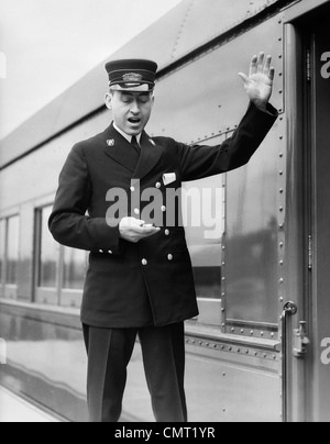 Train conductor on an old-fashioned train Stock Photo, Royalty Free ...