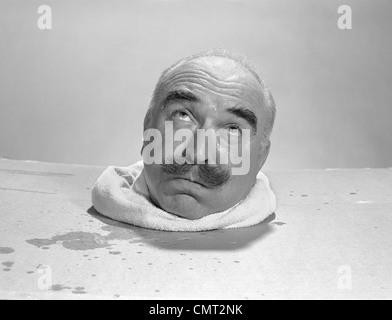 1960s BALD ELDERLY MAN HEAD SWEATING IN STEAM BOX Stock Photo