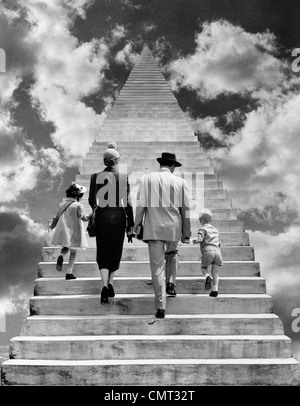 1950s BACK VIEW MONTAGE FAMILY FATHER MOTHER DAUGHTER SON WALKING UP STAIRWAY TOGETHER INTO THE SKY SYMBOLIC Stock Photo