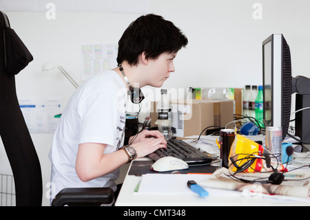 Hacker sitting by the computer Stock Photo
