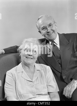 1950s SMILING OLDER MAN WOMAN SENIOR CITIZEN STANDING TOGETHER IN ...