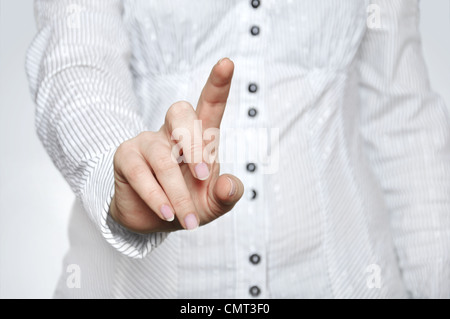 Woman pressing imaginary button with one hand Stock Photo