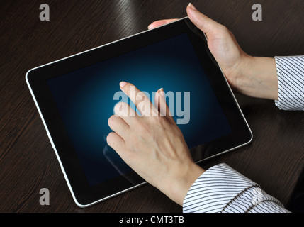 female hand touching screen on modern digital tablet pc. Stock Photo