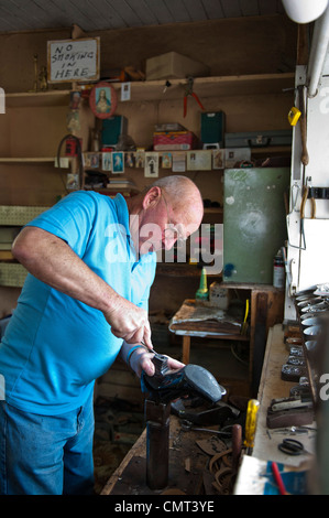 Shoemaker at work in his shop in Arklow, Co. Wicklow, Ireland Stock Photo
