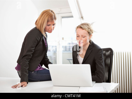 Two women working on laptop Stock Photo