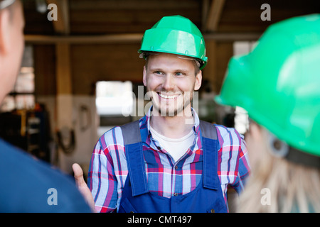 Industrial workers having a conversation Stock Photo