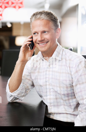 Happy businessman talking on cell phone Stock Photo