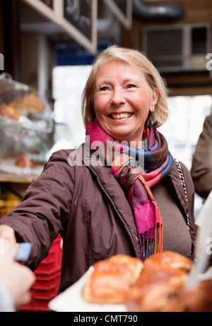 Happy woman paying through credit card Stock Photo