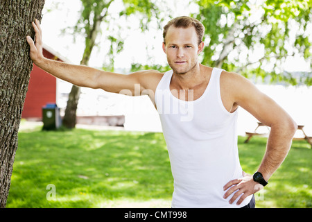 Man leaning against tree Stock Photo