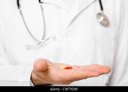Male doctor showing a pill on his palm Stock Photo