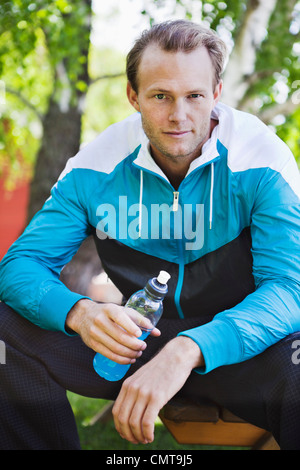 Portrait of man holding sport drink Stock Photo