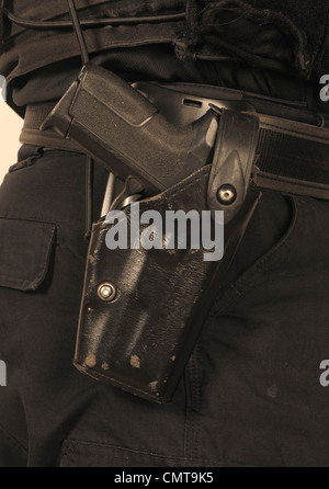 Detail of Police SWAT officer's utility belt with holstered Sig Sauer 9mm automatic pistol. Real police SWAT officer. Stock Photo
