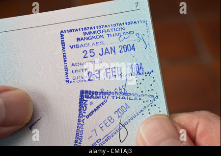 Entry and exit visa stamps of Thailand on a page in a passport Stock Photo